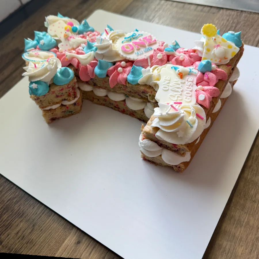 Number fourteen cake decorated with pastel buttercream and sprinkles