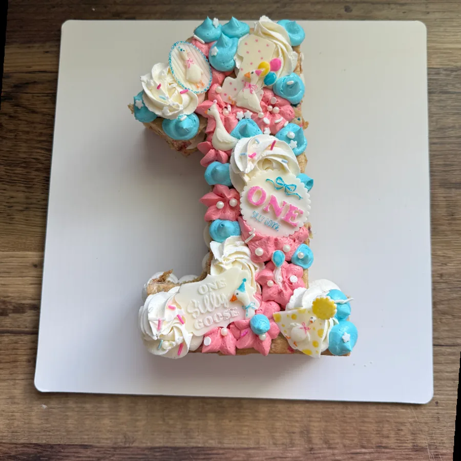 Number one cookie cake decorated in pink and blue for a first birthday