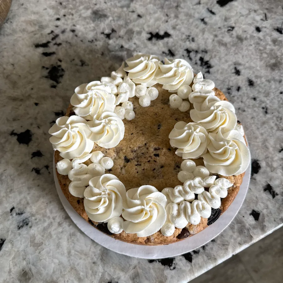Cookies and cream cookie cake topped with swirls of vanilla buttercream