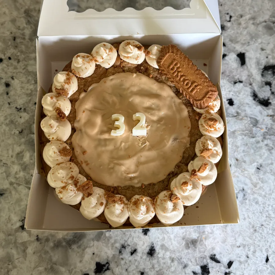 Biscoff cake with a smooth cookie butter top and piped shell border
