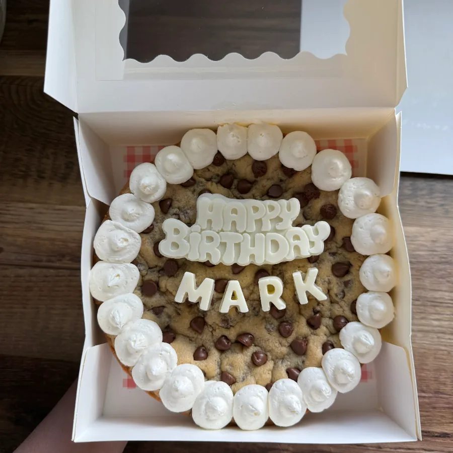 Birthday cake lettered in buttercream inside a bakery box