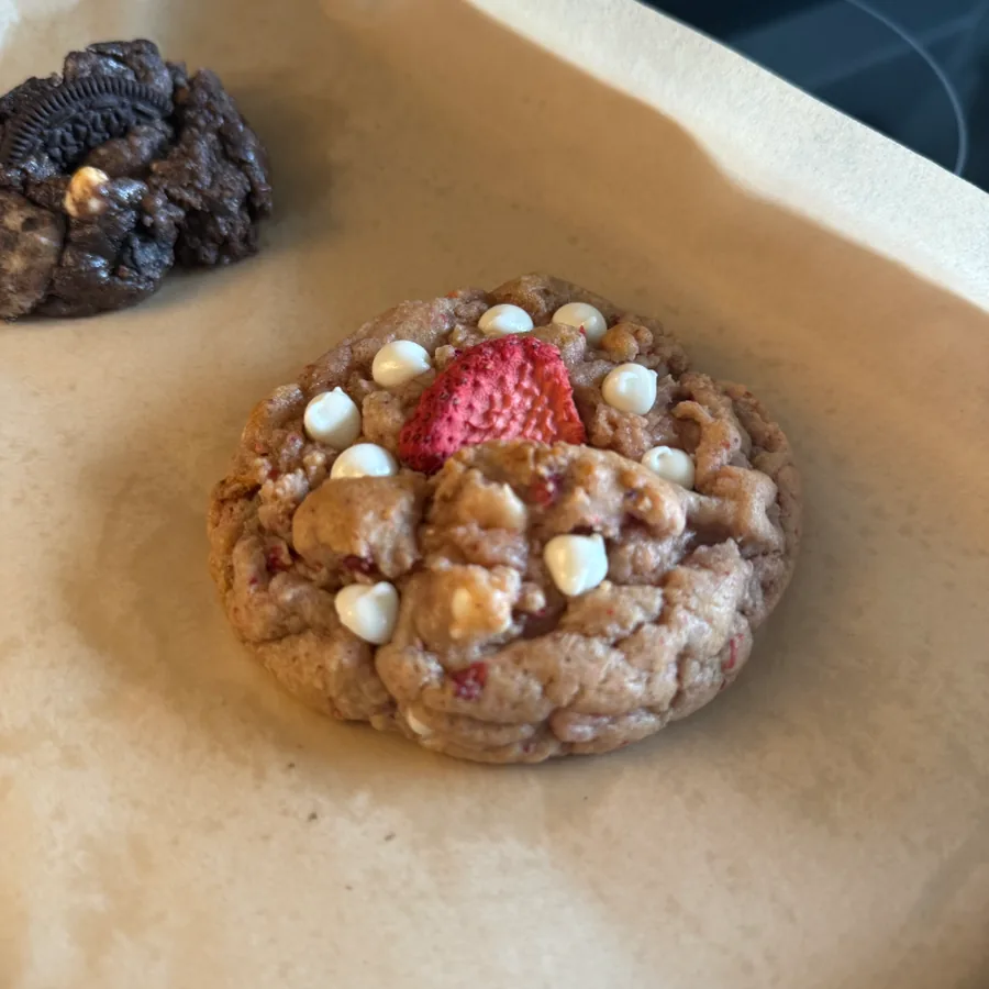 Strawberry cookie topped with white chocolate chips and a freeze-dried strawberry